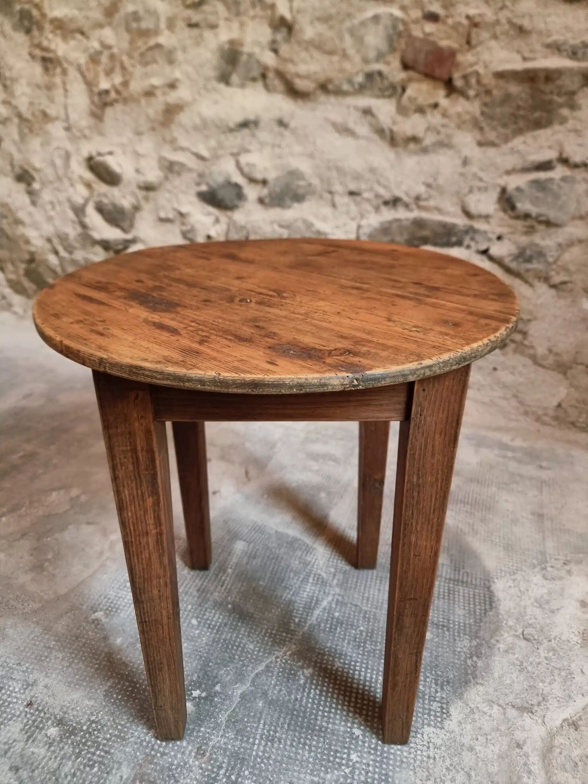 Antique round side table with oak legs and a pine top, circa 1900.