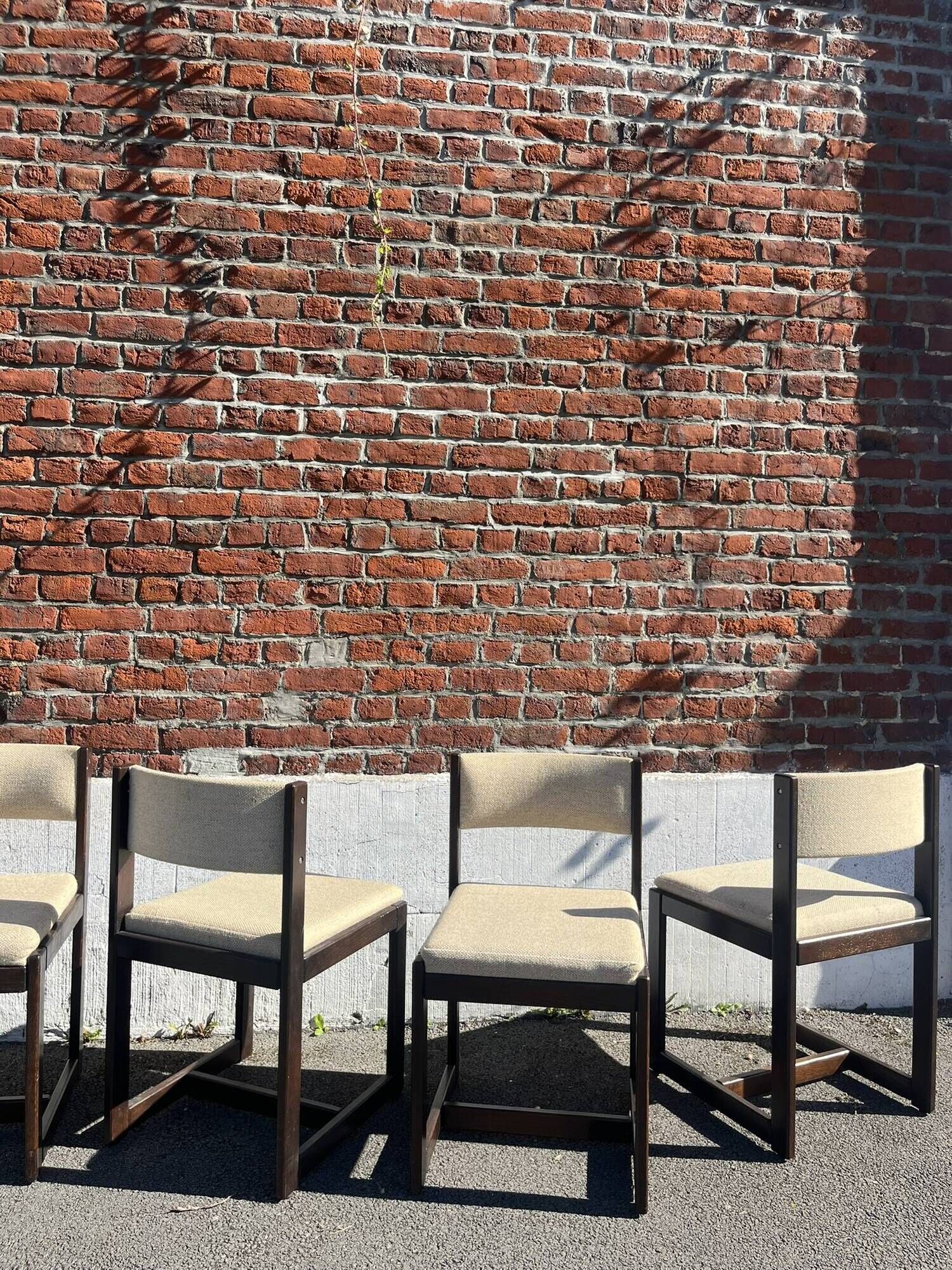Many mid-century vintage wooden and fabric chairs.