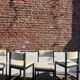 Many mid-century vintage wooden and fabric chairs.