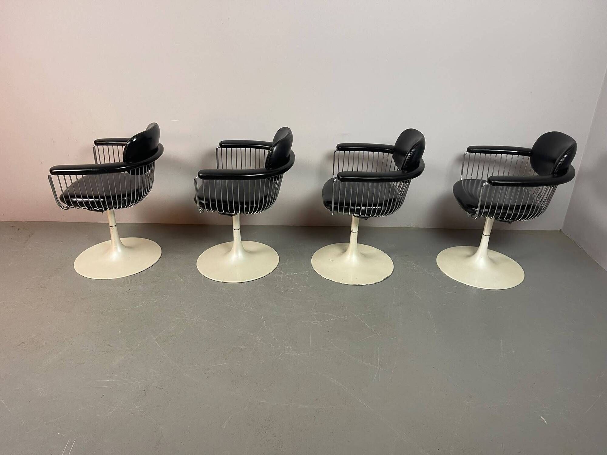 A striking set of four vintage swivel dining chairs