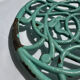 Enamelled cast iron trivet in blue with wrought iron decoration.