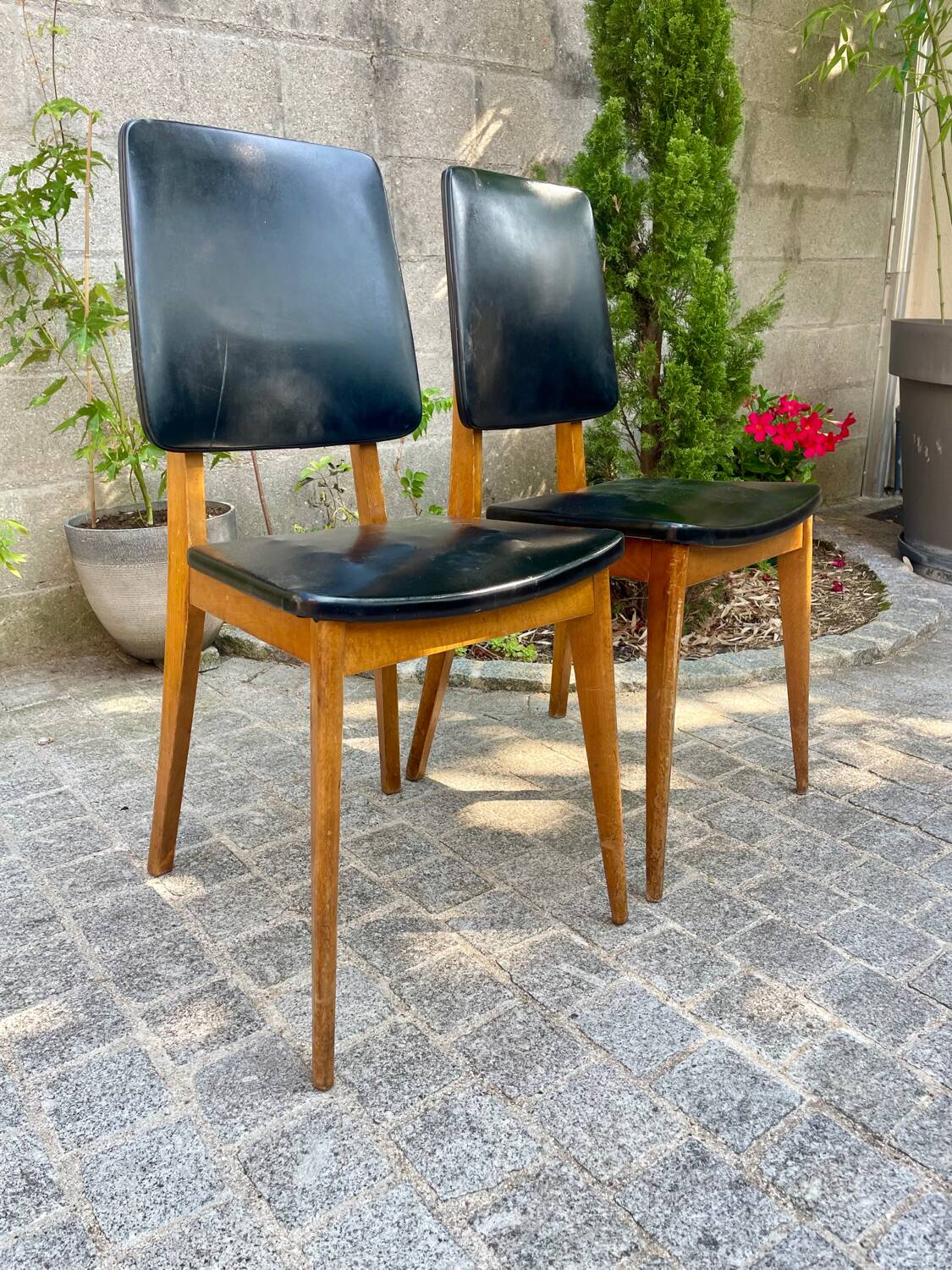 Two vintage Scandinavian chairs in beech and black leatherette
