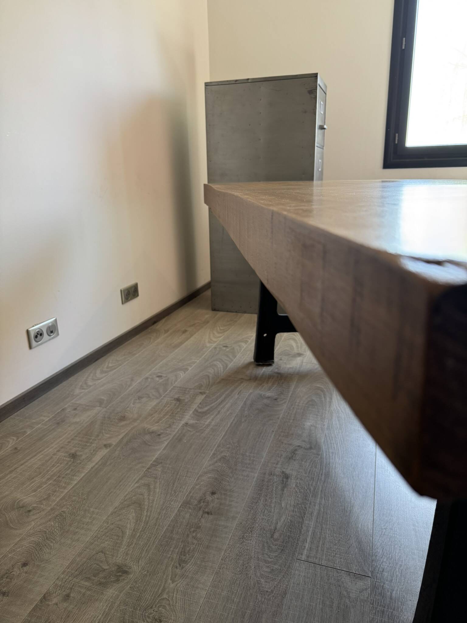 Industrial style table with a mahogany top.
