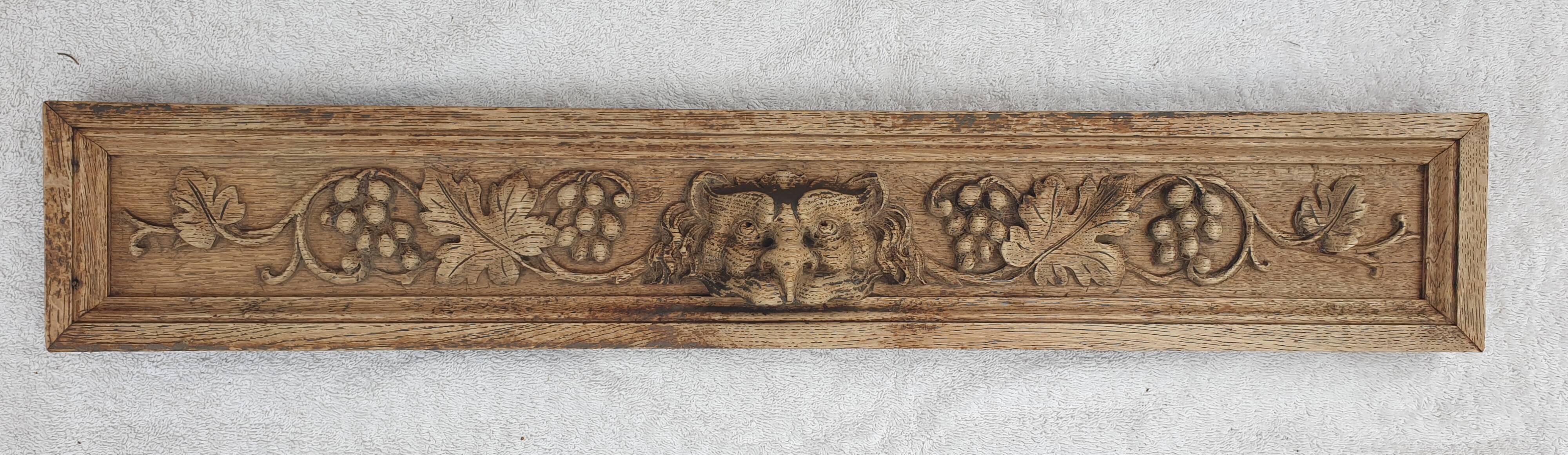 Natural wood pediment with bunches of grapes