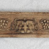 Natural wood pediment with bunches of grapes