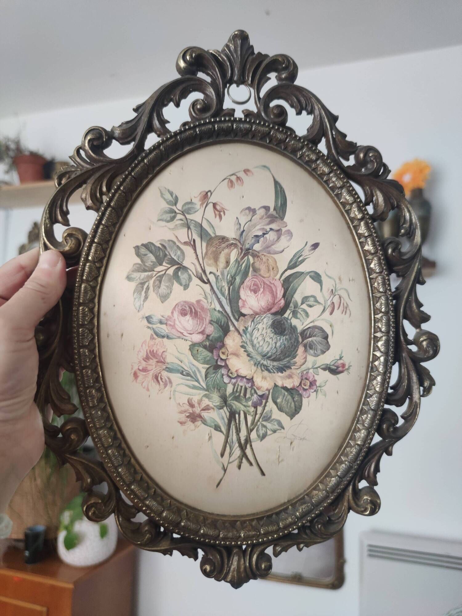 Golden brass frame with bouquet of flowers on silky fabric