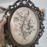 Golden brass frame with bouquet of flowers on silky fabric