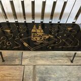 Vintage black and gold glass coffee table with conical legs from the 1940s.