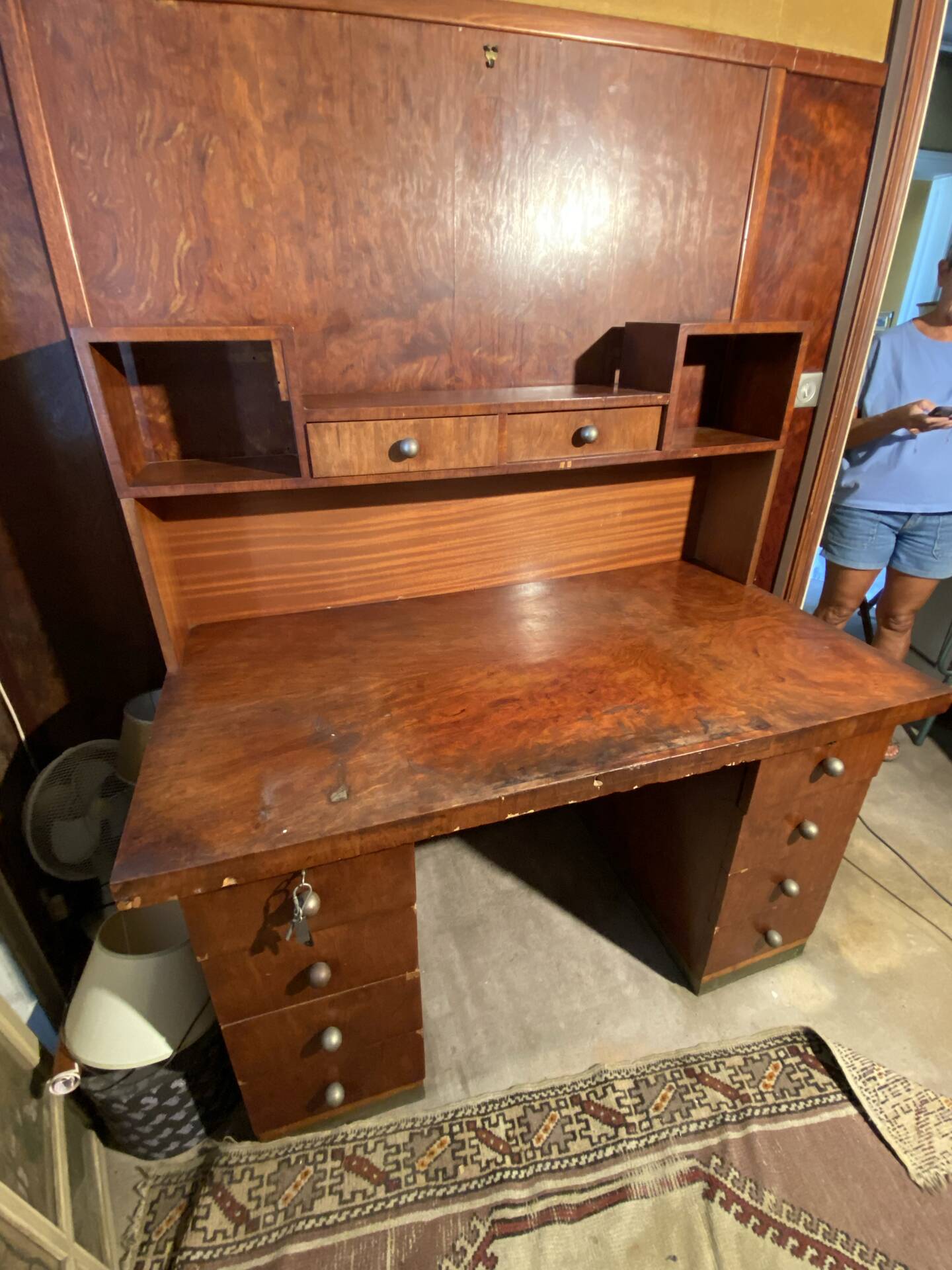 Vintage desk with drawers and a hutch with numerous drawers.