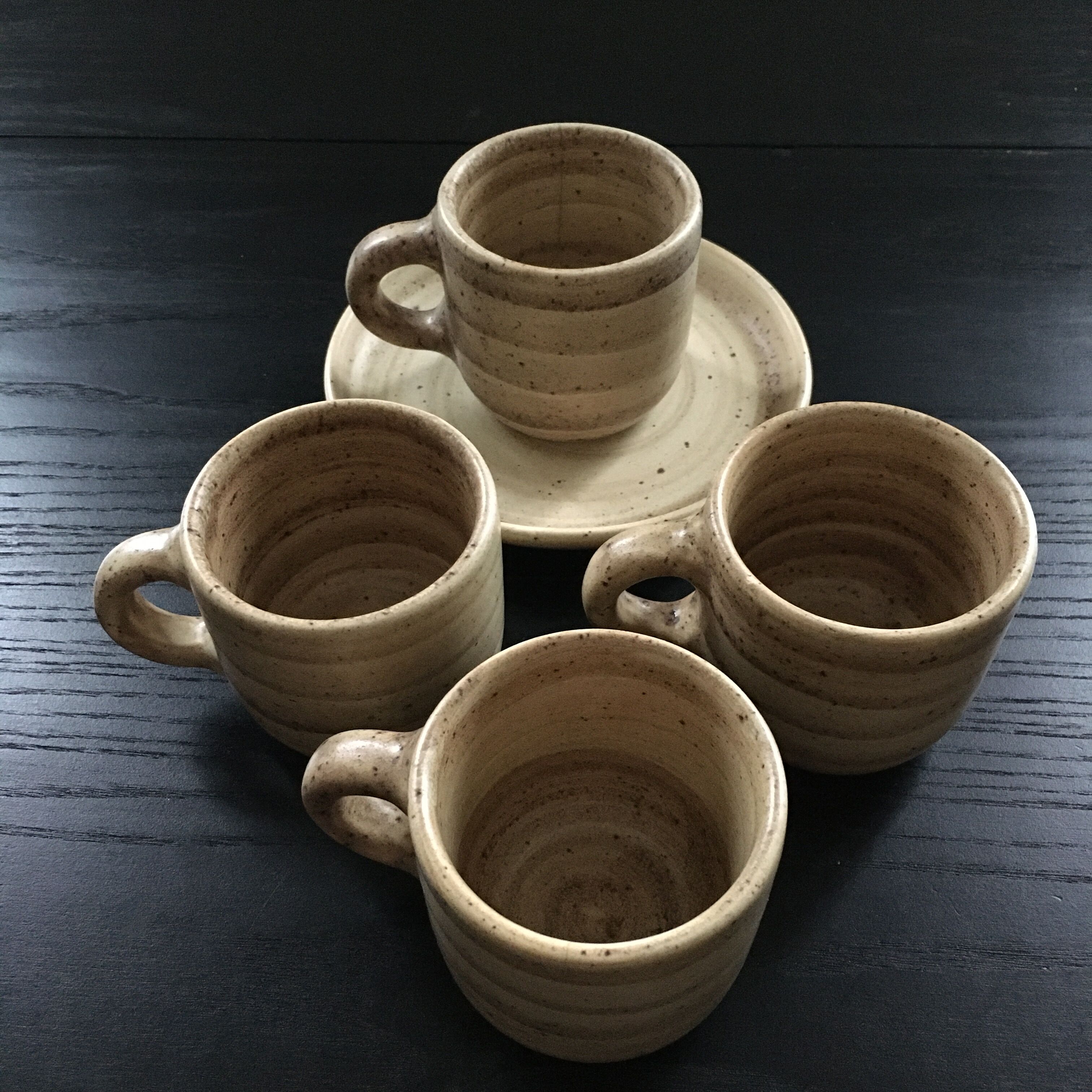 Set of 4 beige stoneware mugs.