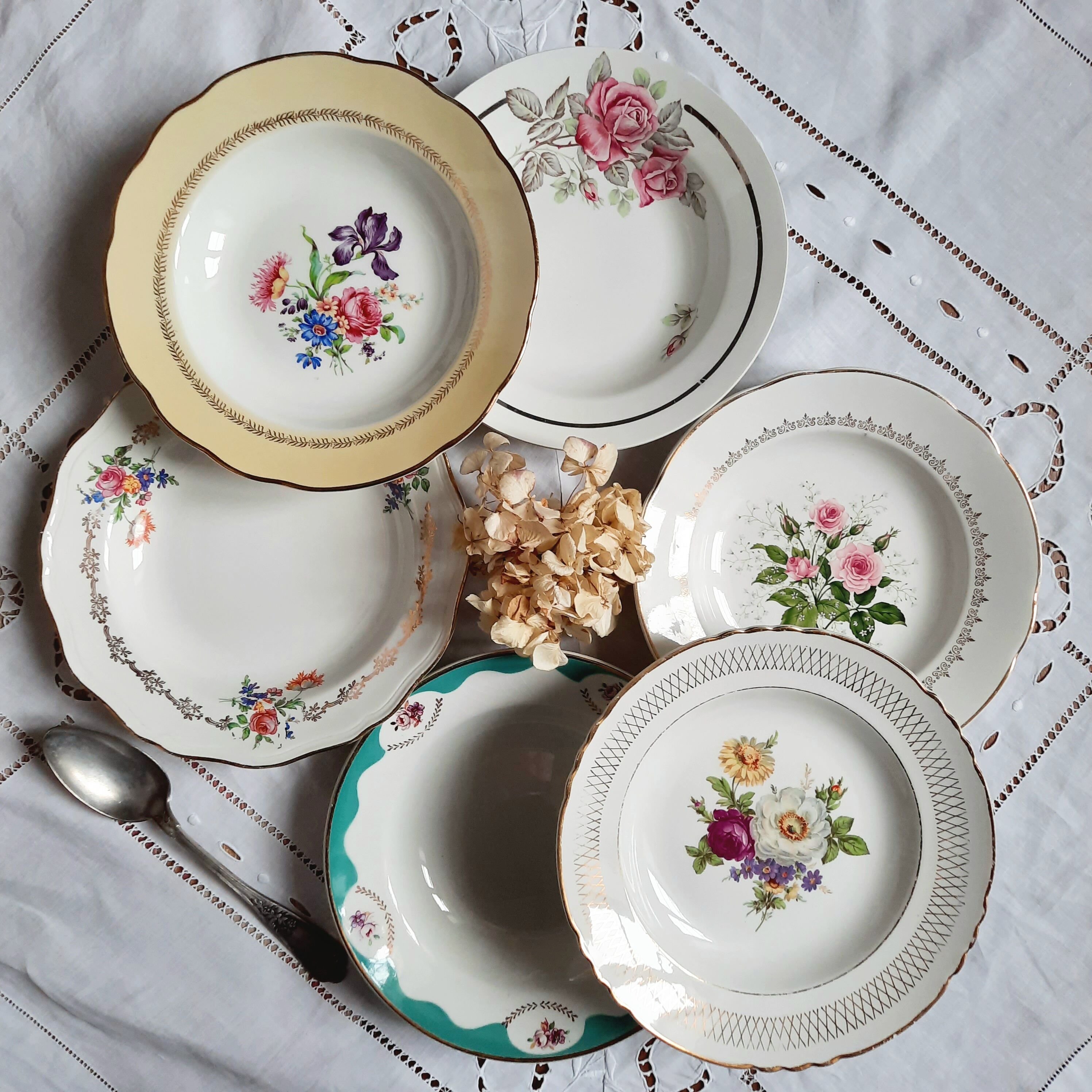 Old hollow plates mismatched in earthenware with gilded edges