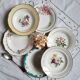 Old hollow plates mismatched in earthenware with gilded edges