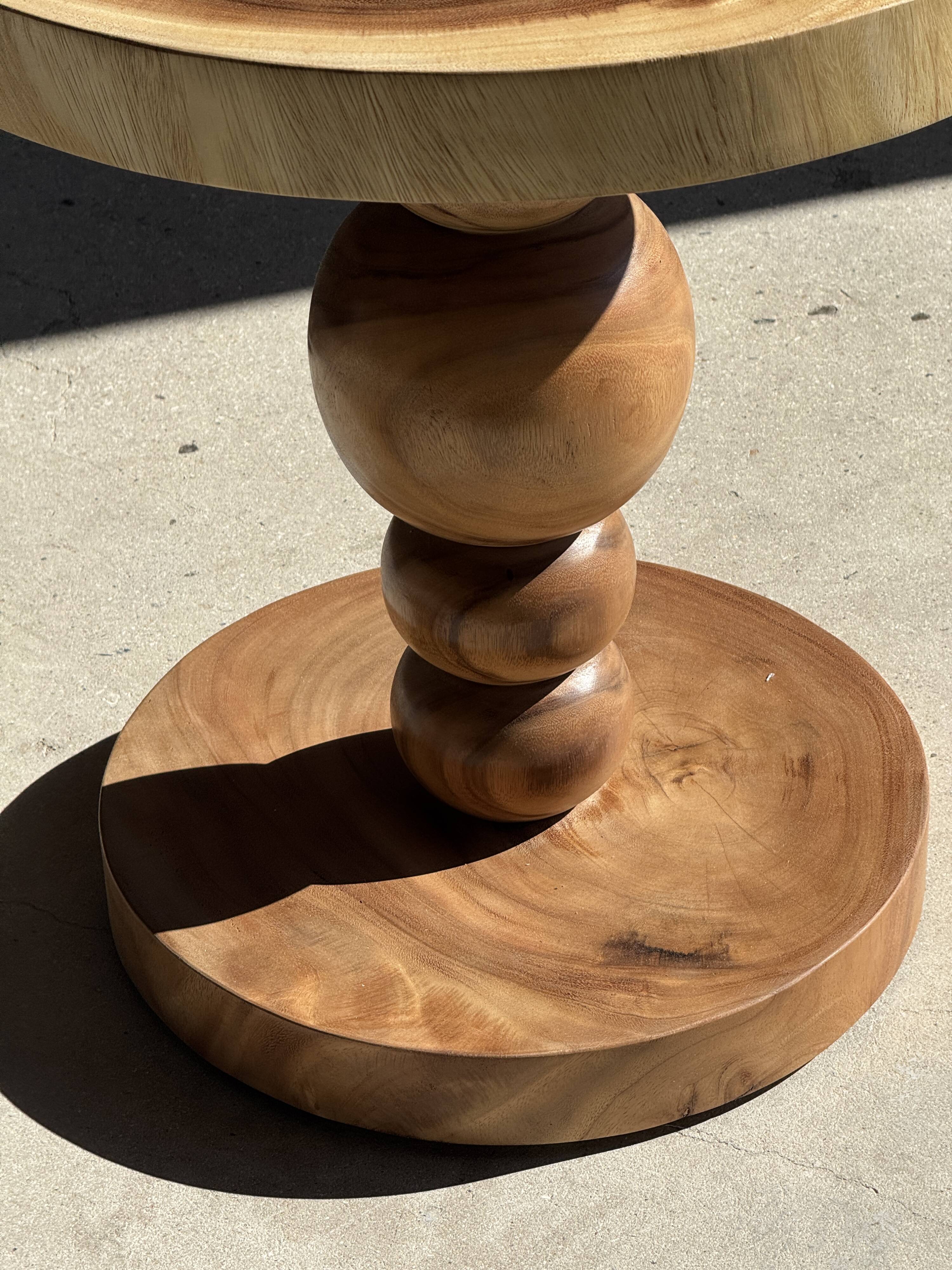 Coffee table in solid suar with central leg and spheres H56.5 D55.5
