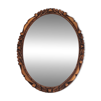 Oval wall mirror in gilded wood