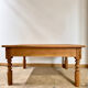 Antique coffee table in solid elm with turned legs.