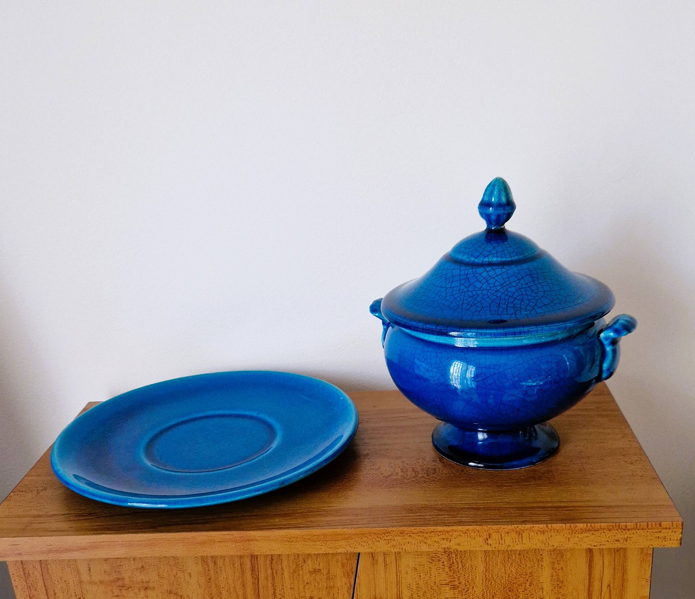 Blue ceramic soup tureen and crackled finish trivet.