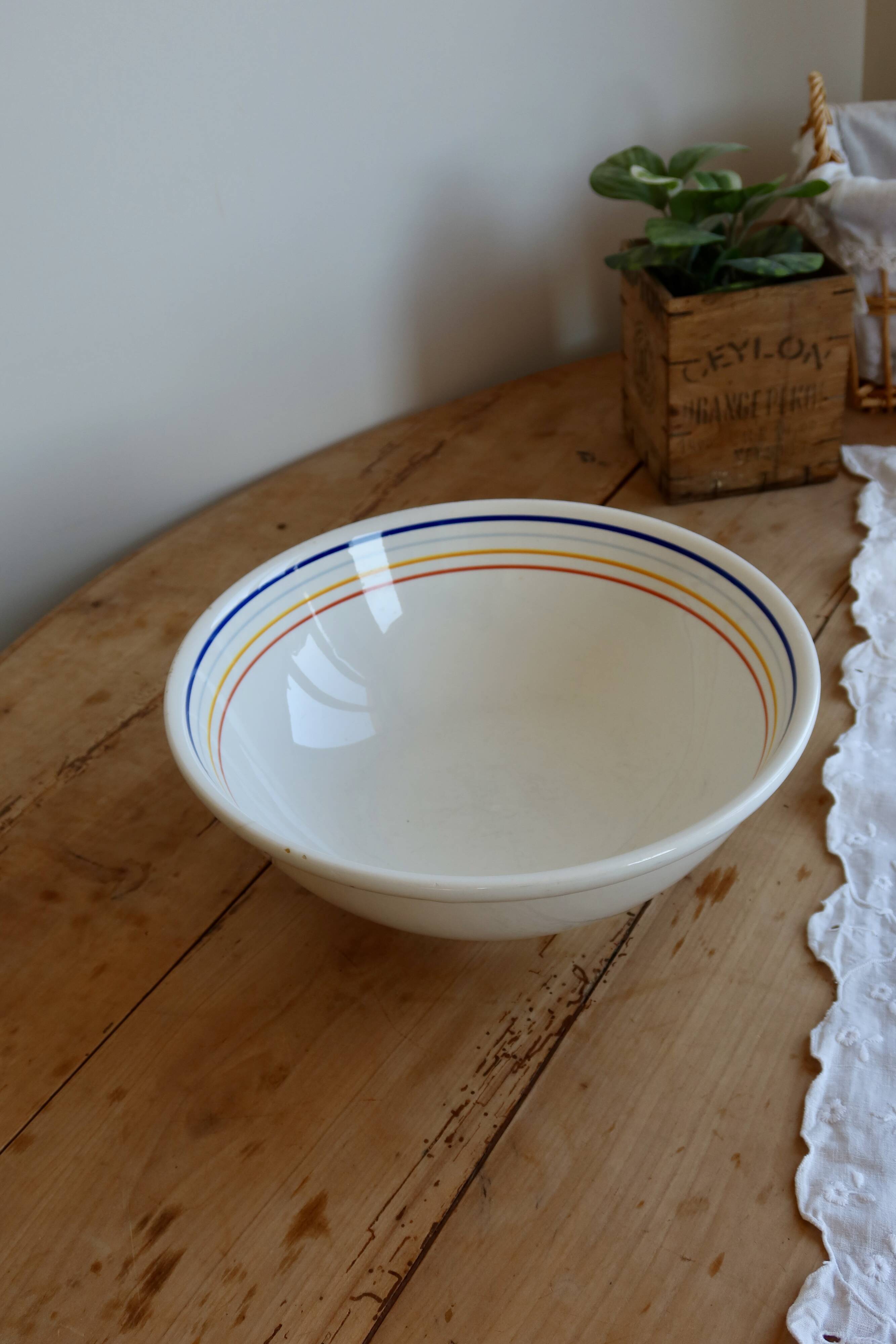 Vintage porcelain salad bowl with multicoloured borders.