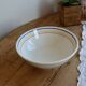 Vintage porcelain salad bowl with multicoloured borders.