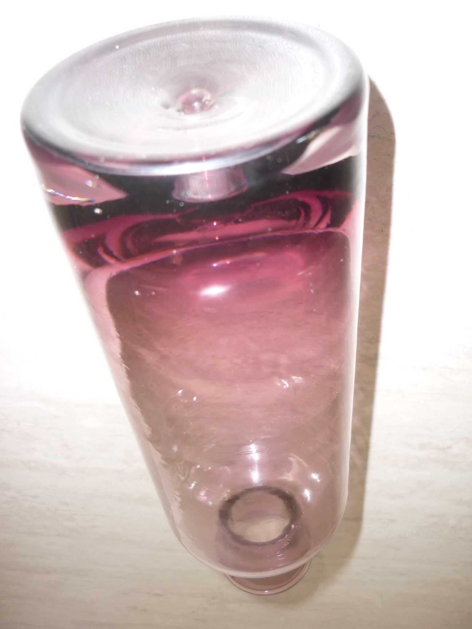 Plum-colored glass bottle with bubble
