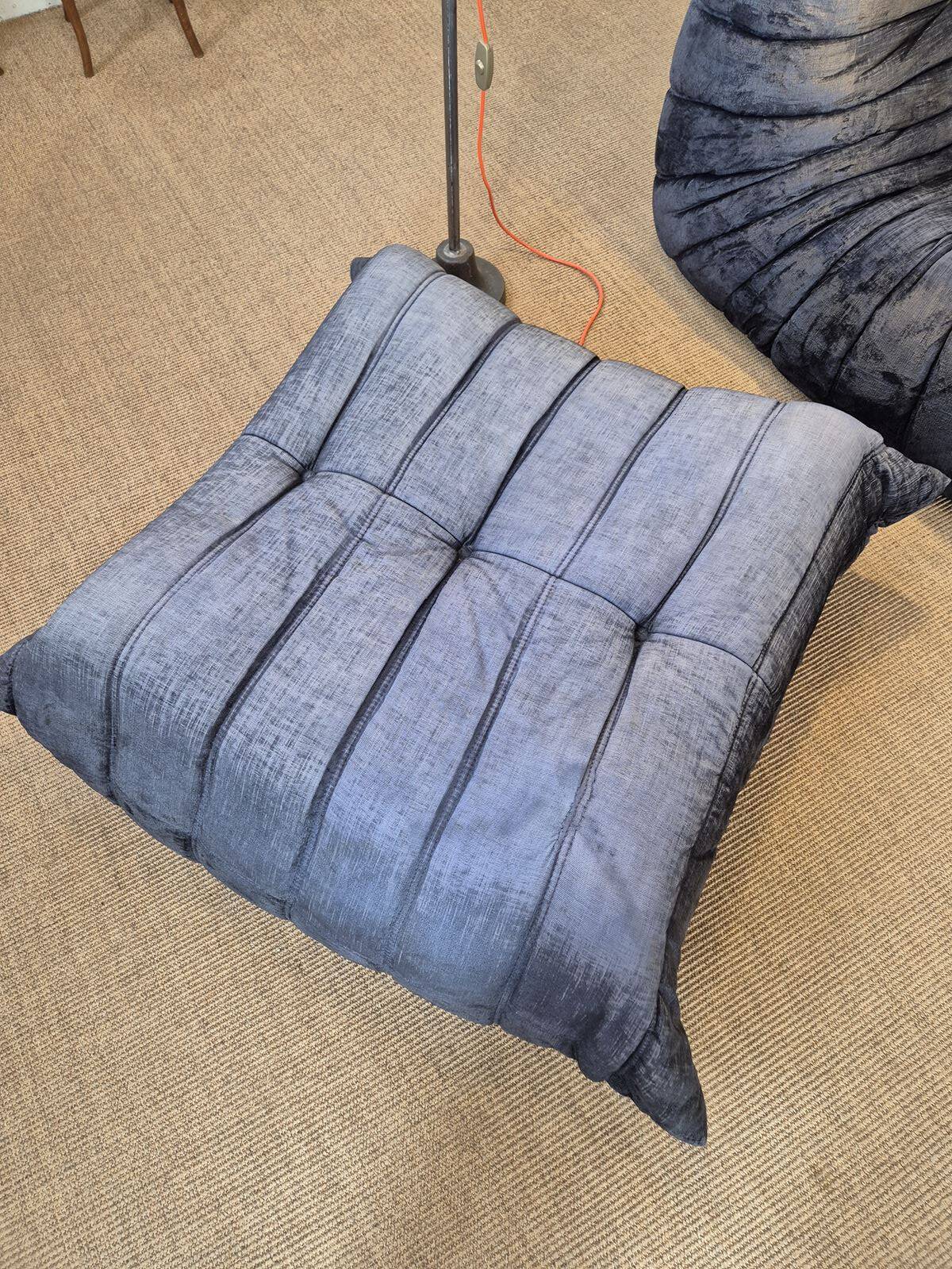 Togo sofa by Ligne Roset and its pouf from the 1970s.