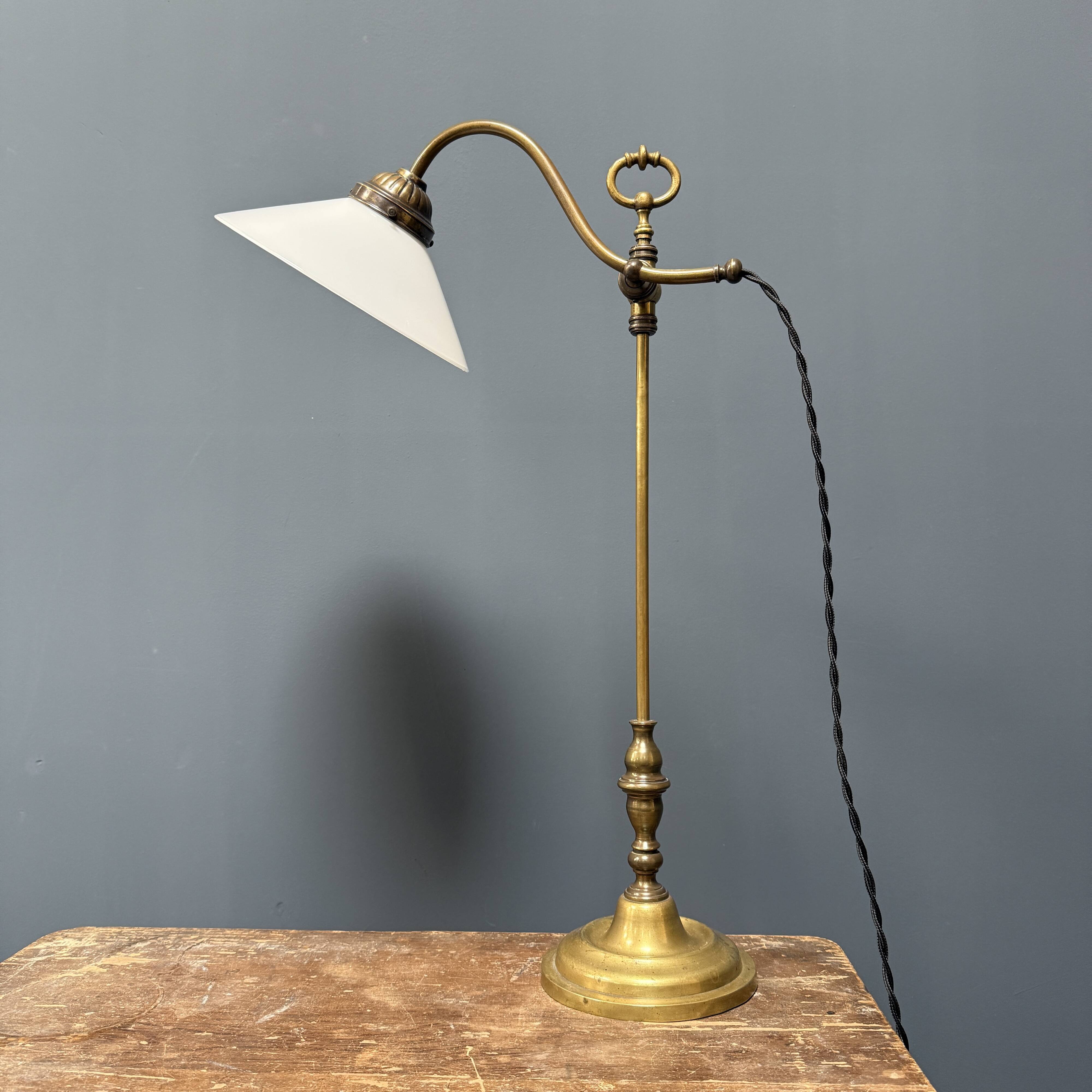 Adjustable brass table lamp with opaline glass shade