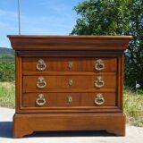 Chest of drawers with decorated handles in the Louis XVI style.