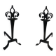 Important pair of wrought iron andirons with torch in heraldic fleur-de-lis design.