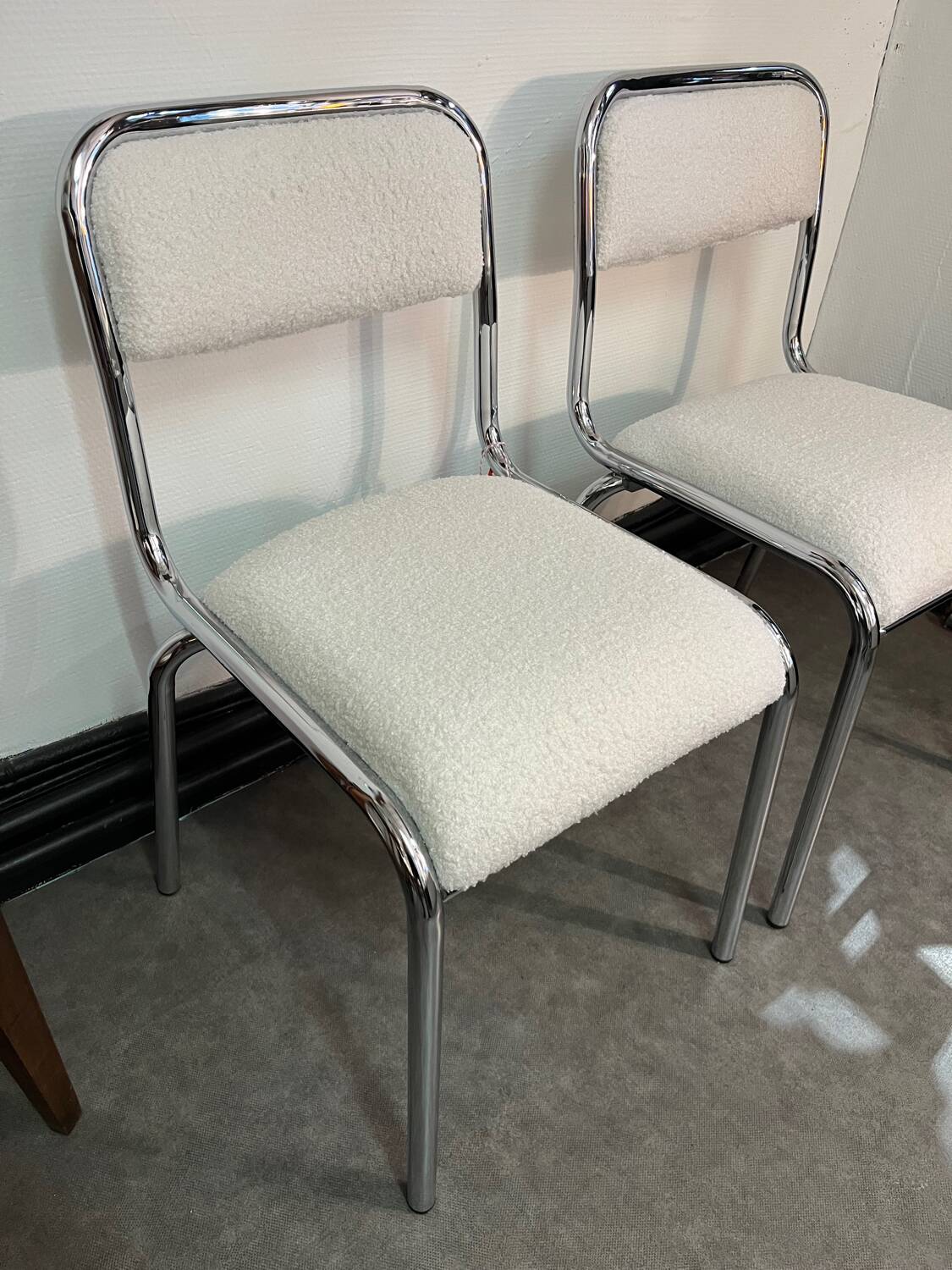 Pair of chrome chairs upholstered in boucle fabric.