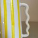 Lemon yellow and white striped ceramic vase with abstract wavy handmade handheld