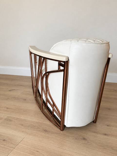 ENNIO armchair in quilted white leather with a copper stainless steel frame.
