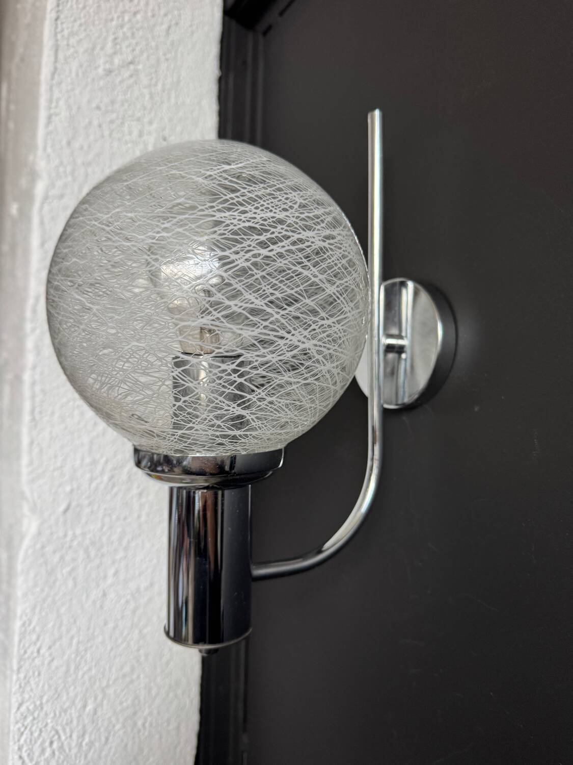 Chrome wall light with blown glass from the 1970s.