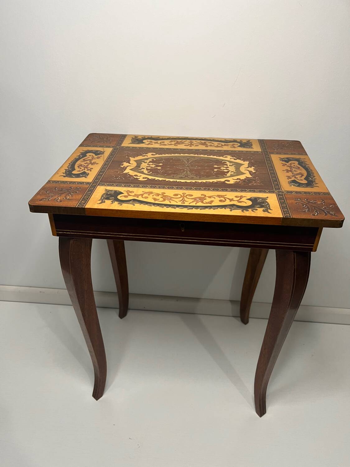 Small antique Italian inlaid table with Swiss music box.