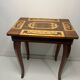Small antique Italian inlaid table with Swiss music box.