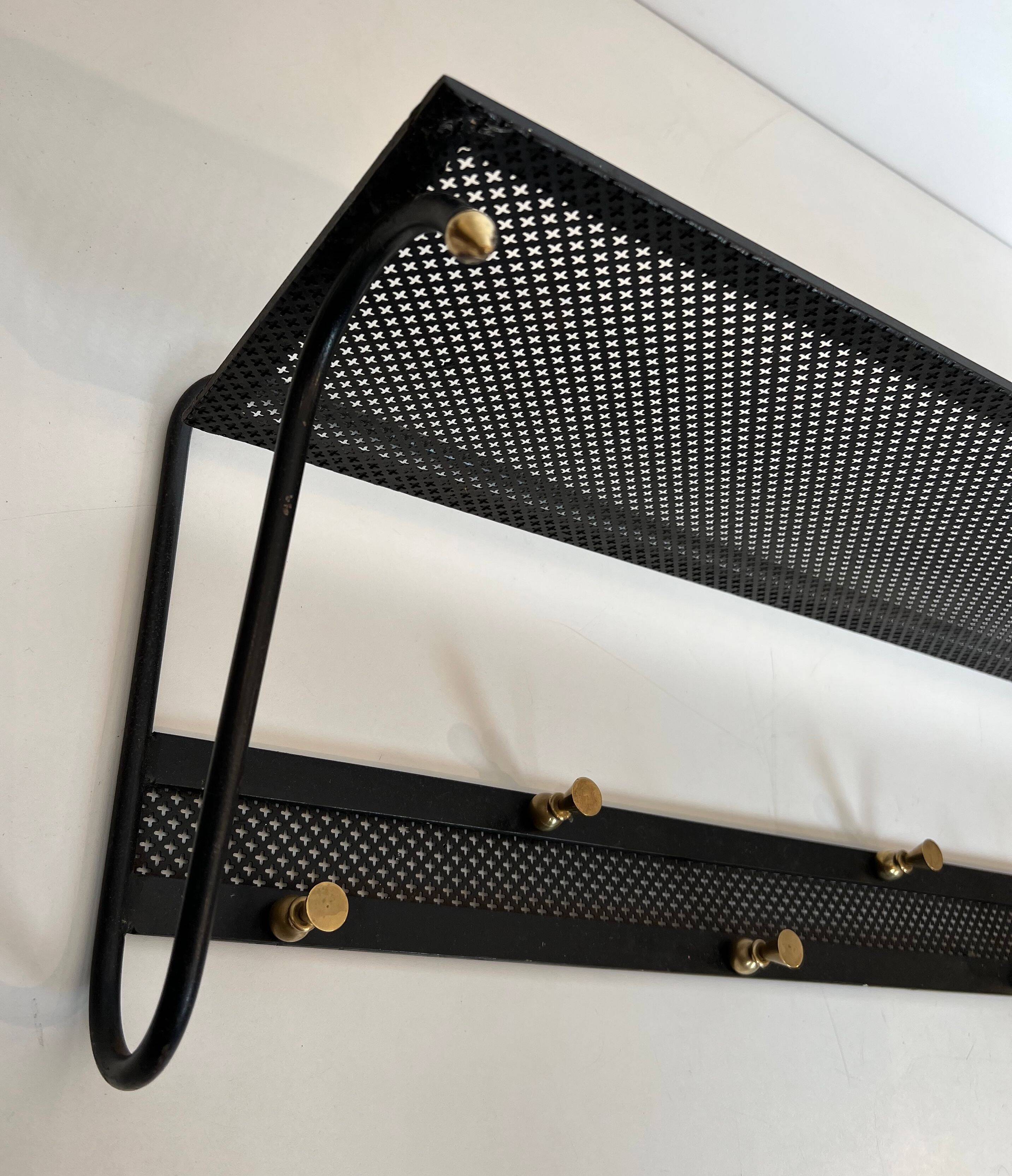 Coat rack in black lacquered metal, perforated sheet metal and brass in the style of Mathieu Matégot