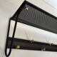 Coat rack in black lacquered metal, perforated sheet metal and brass in the style of Mathieu Matégot