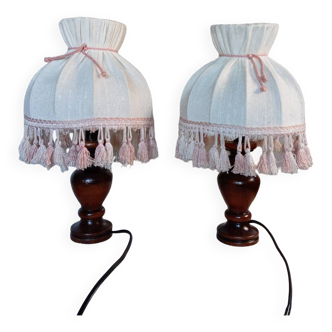 Pair of retro wooden lamps and ecru fabric dome lampshades with pink fringes