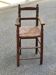 Child's high chair booster from the 19th century in solid wood with rush seating.