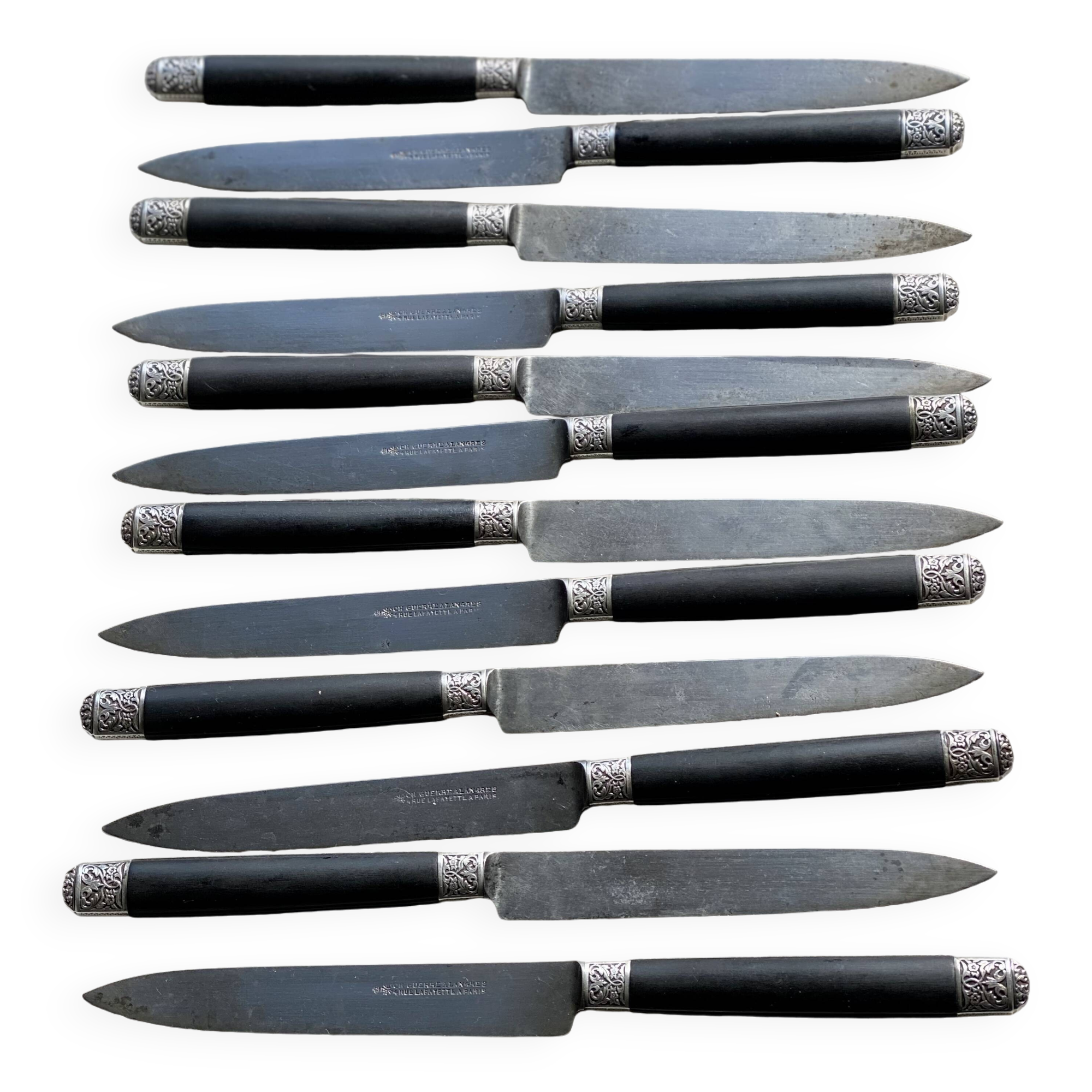 Set of 12 19th century table knives with ebony and chiseled silver handles