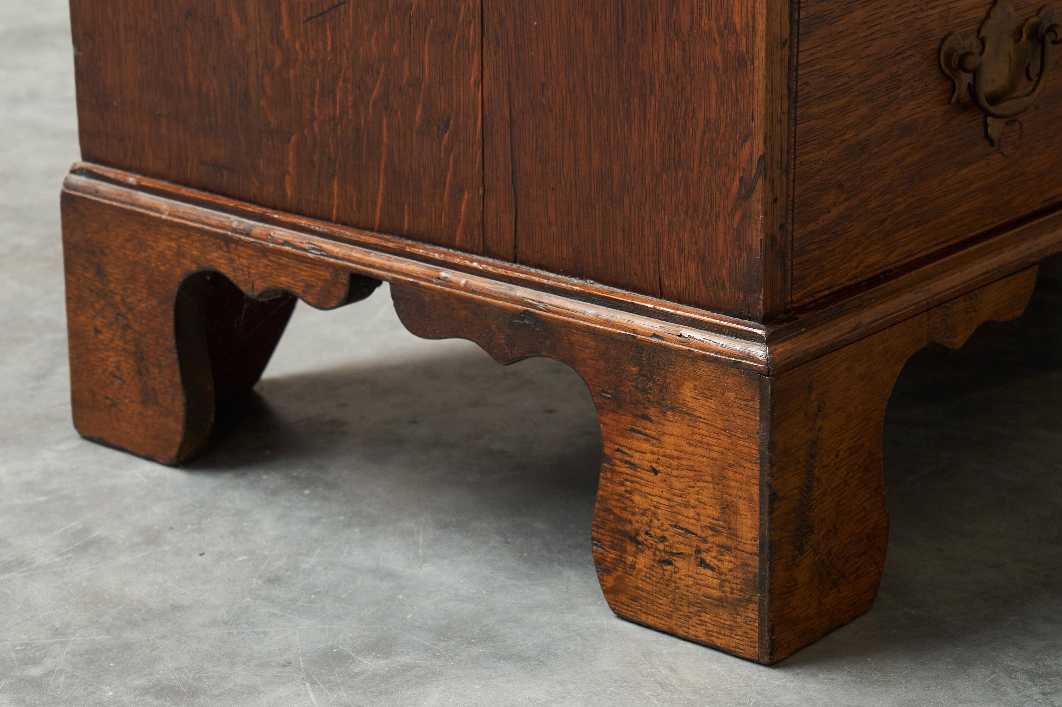 Antique English oak secretary with drop-down front.