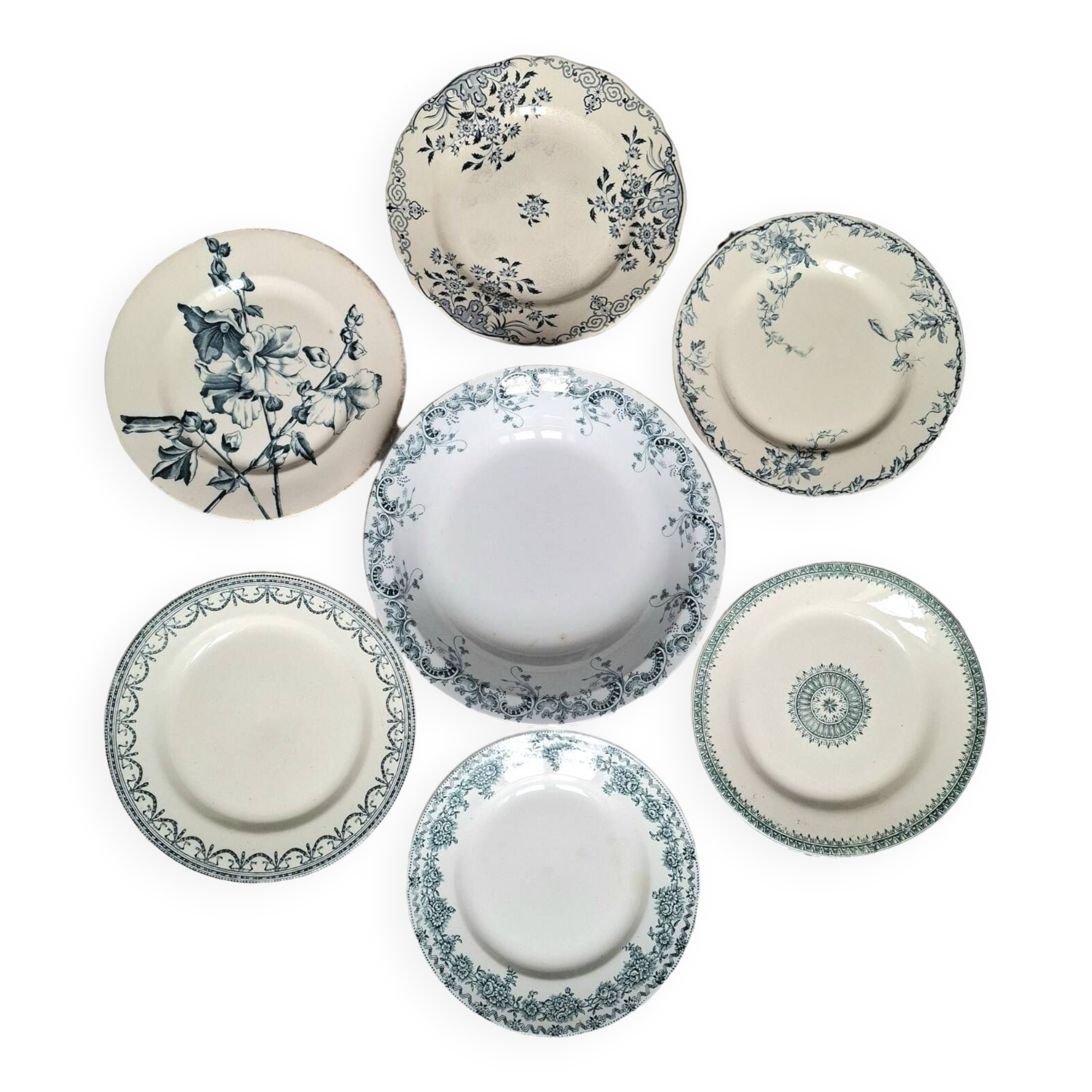 Old mismatched flat plates in iron earth earthenware accompanied by a dish