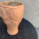 Terracotta vase with a vintage ceramic relief rose pattern