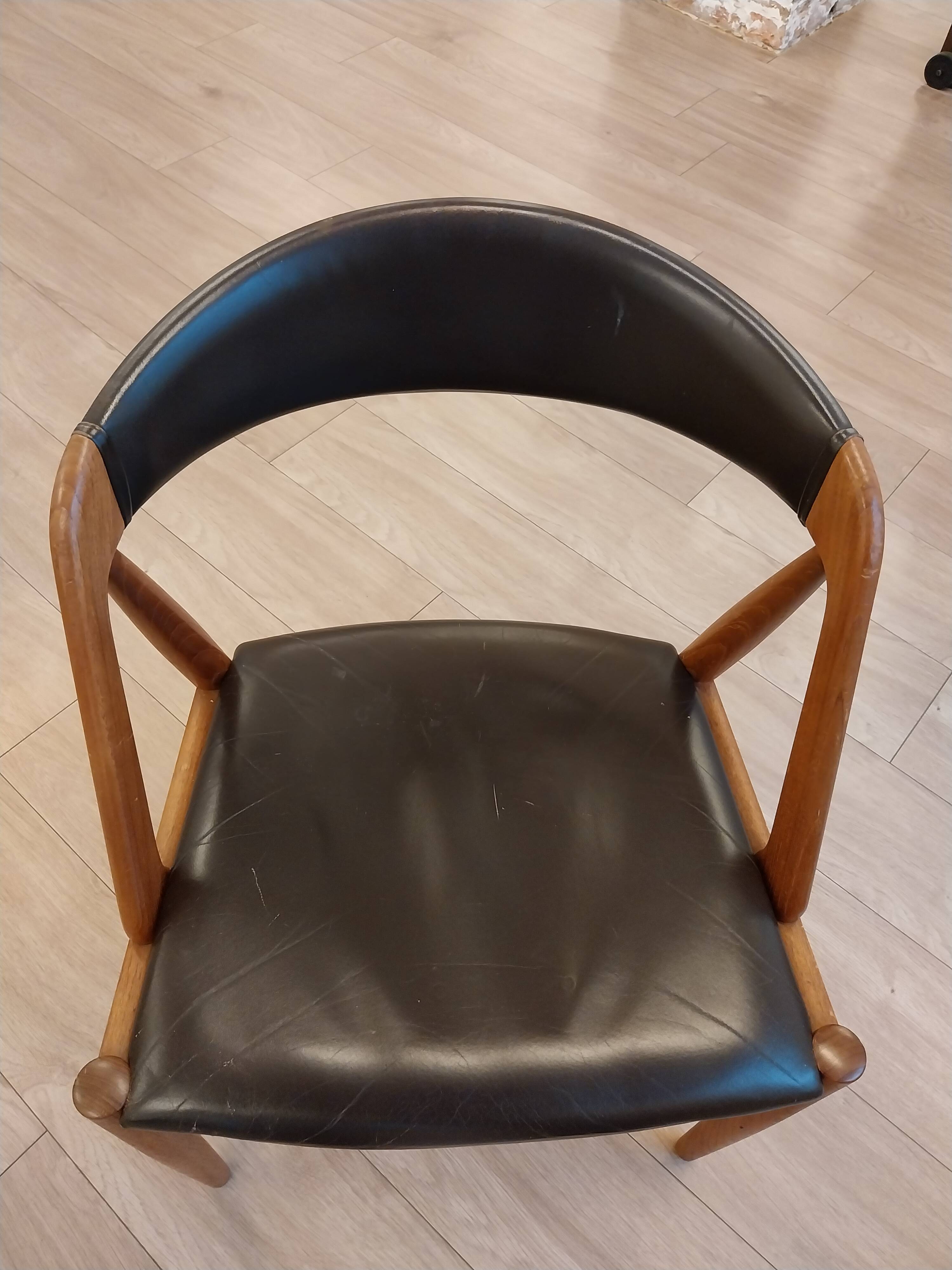 Set of 6 vintage Kai Kristiansen chairs in solid teak and black faux leather.