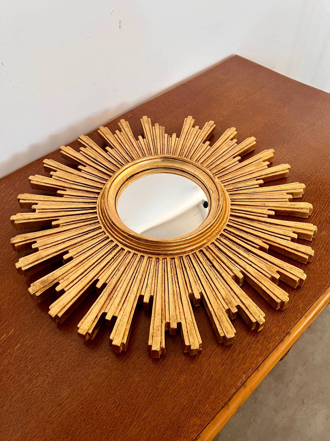 Old large golden sun mirror with rounded witch's eye in vintage resin from the 70s