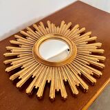 Old large golden sun mirror with rounded witch's eye in vintage resin from the 70s