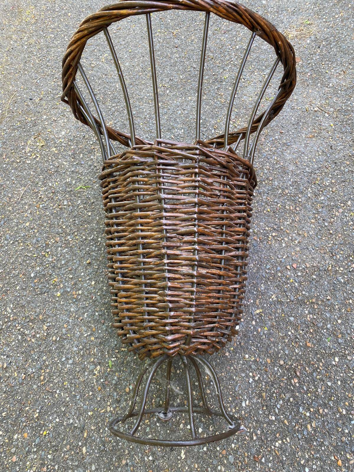 Vintage umbrella stand in rattan, woven wicker, and steel.