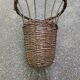 Vintage umbrella stand in rattan, woven wicker, and steel.