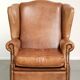 Sheepskin wingback armchair in a light cognac colour in English style