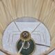 Brass table lamp with green patina and empire-style fabric shade.