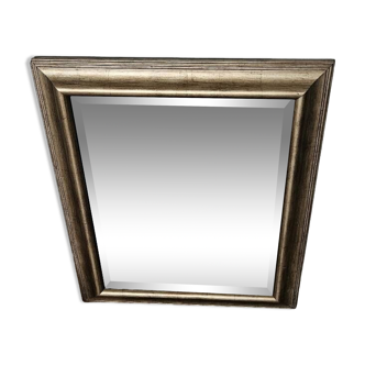 Beveled mirror under gold frame
