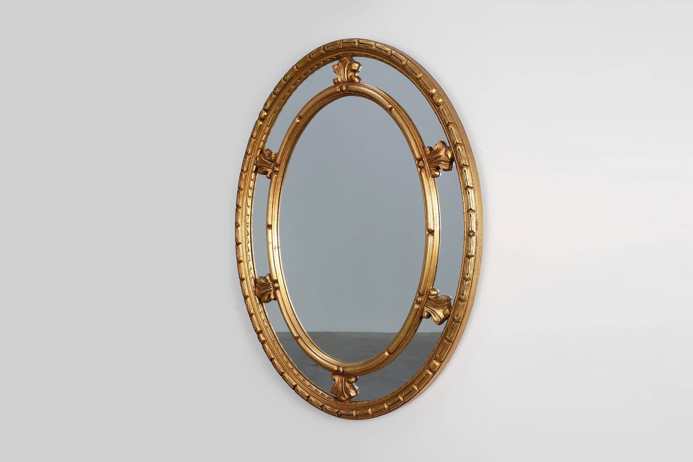 20th century neo-classical style tilted oval mirror by Deknudt, Belgium